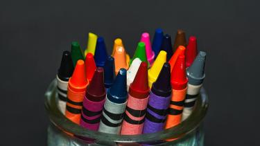 colourful crayons in a container